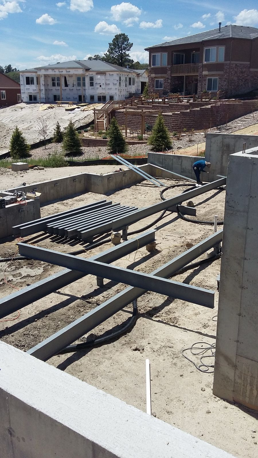 Black Steel crew setting steel beams for a structural floor