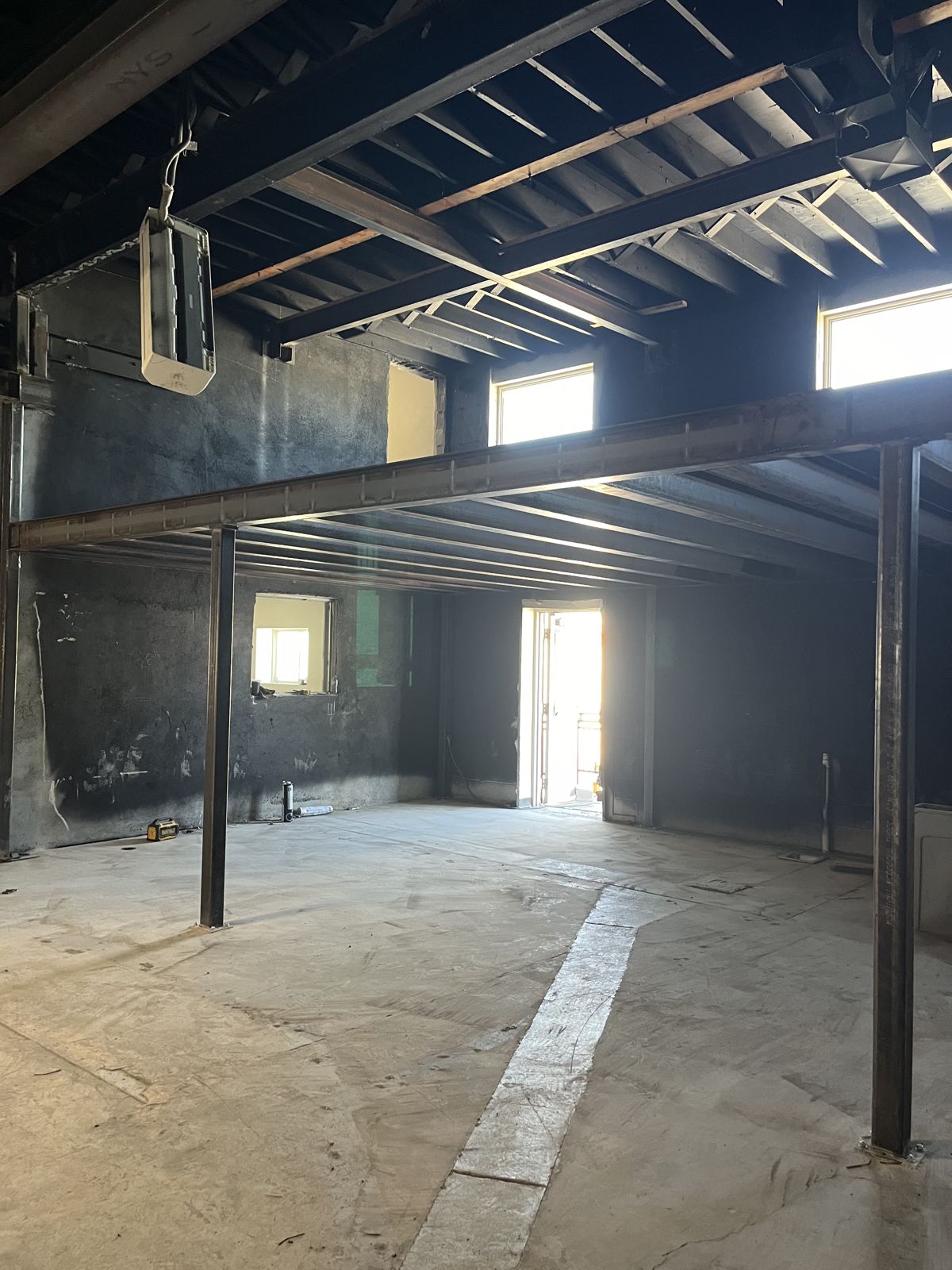 Steel beam and posts carrying the floor framing inside a commercial building